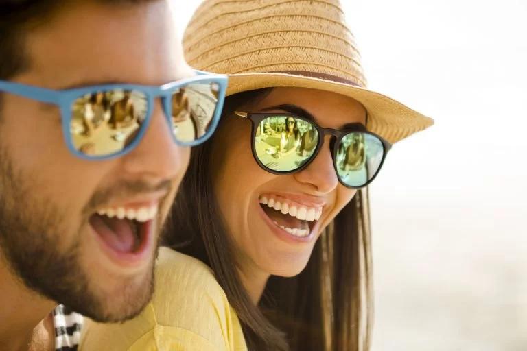 Two people laughing in sunglasses